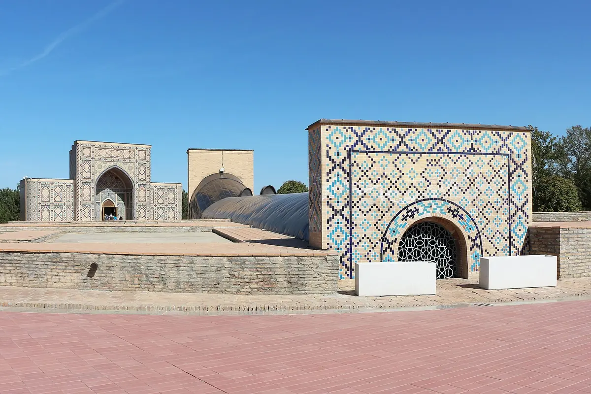 The tiled entrance structure of the Ulugh Beg Observatory in Samarkand under a blue sky